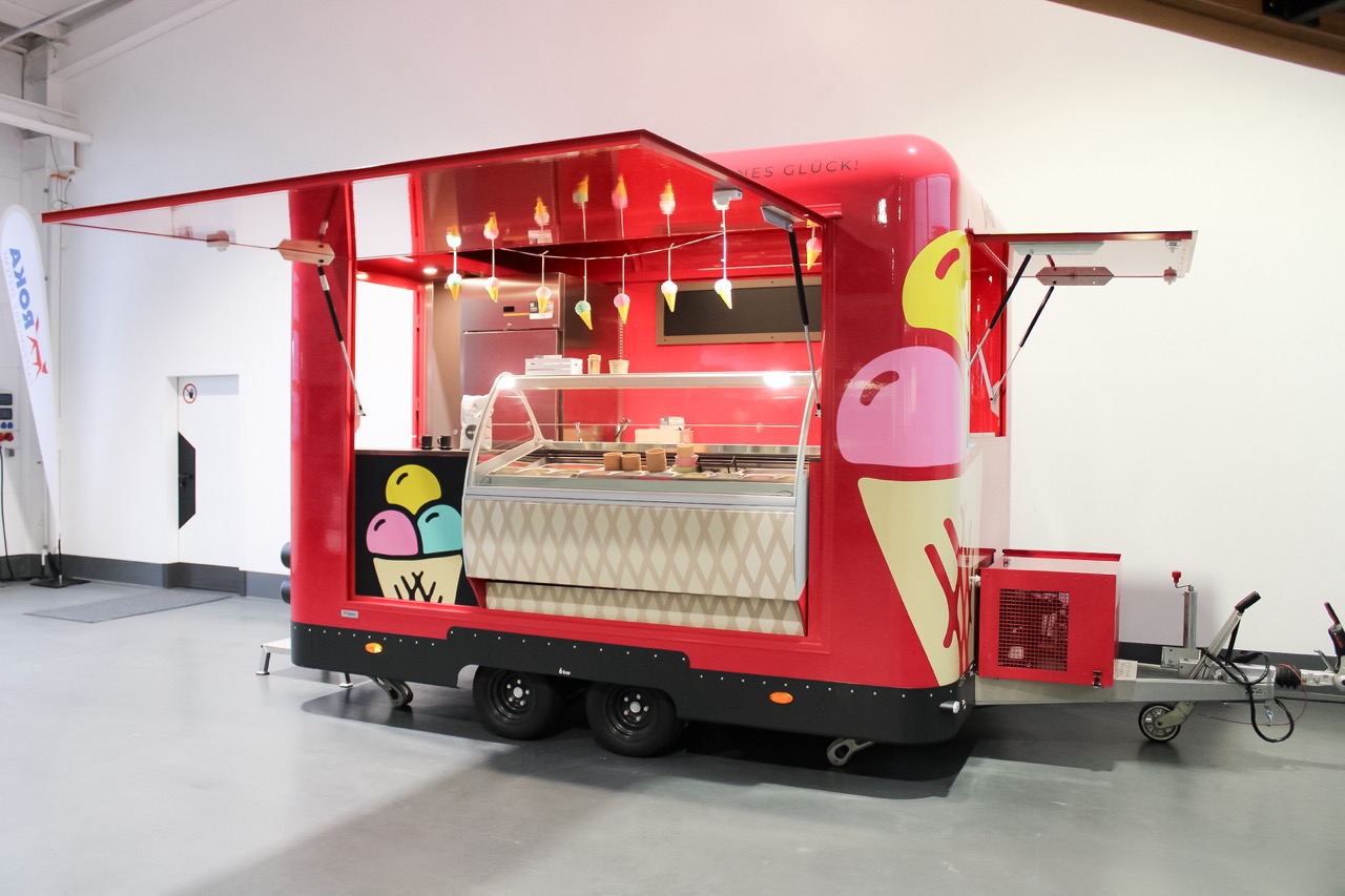 ROKA ice cream trolley in raspberry red with large ice cream display case for mobile ice cream sales. Buy, rent, lease!
